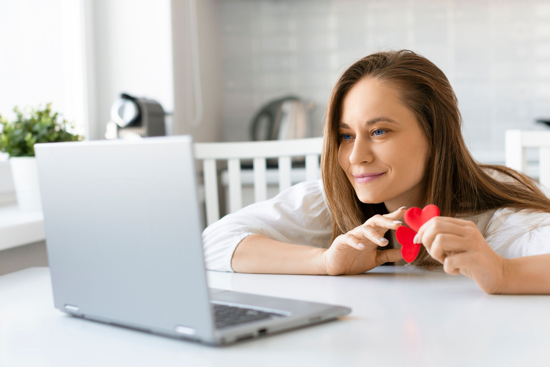 Young woman in front of a laptop screen during an online date